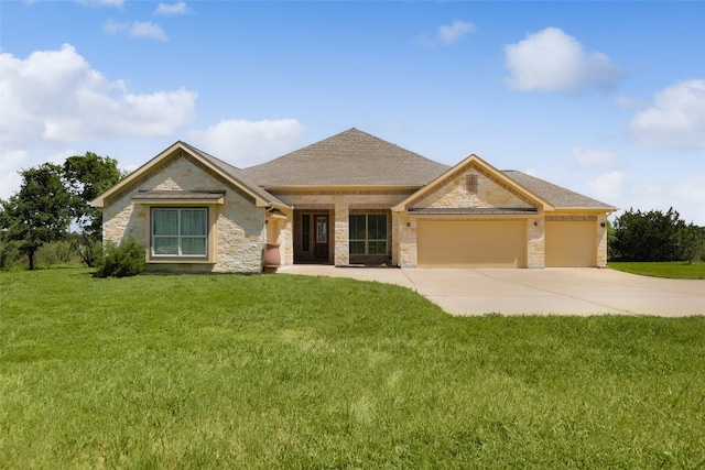 view of front of home featuring a front yard and a garage