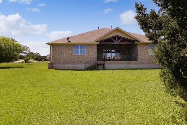 rear view of house featuring a lawn