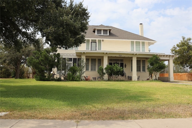 view of front of house featuring covered porch and a front lawn