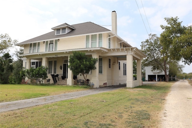 view of front of home featuring covered porch and a front lawn