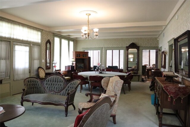 carpeted dining room featuring an inviting chandelier, beam ceiling, and a wealth of natural light