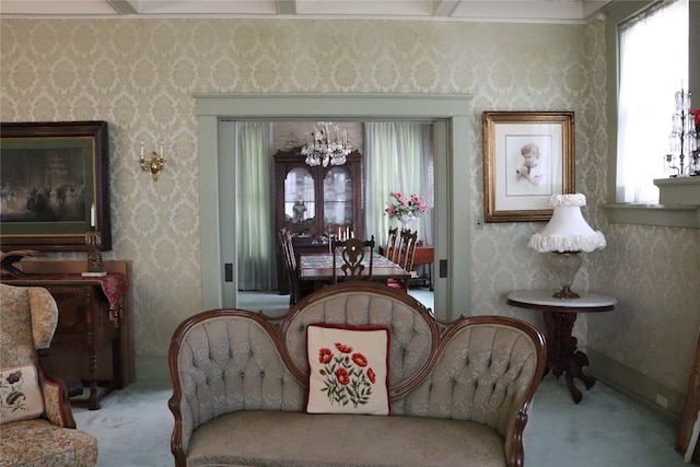 sitting room featuring light carpet, a chandelier, and a wealth of natural light