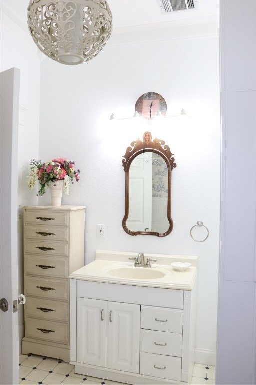 bathroom with vanity and ornamental molding