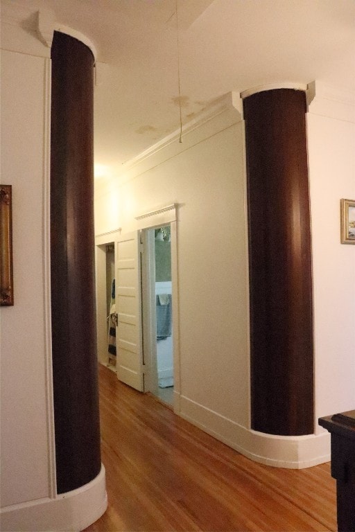 corridor with crown molding and wood-type flooring