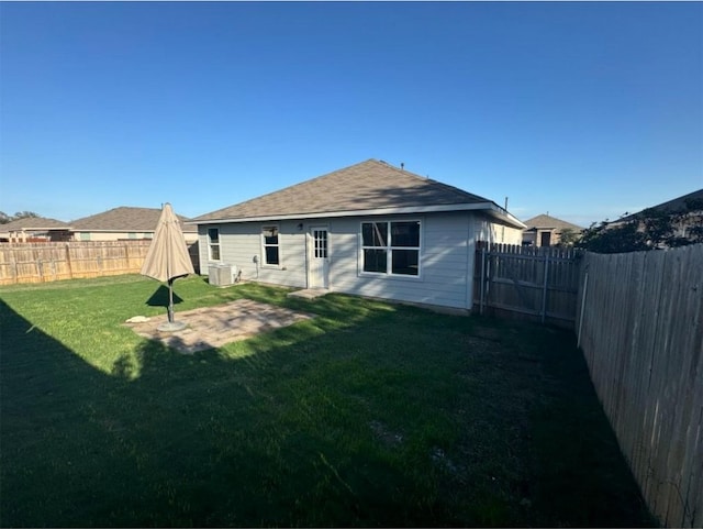 back of property with a patio area and a yard