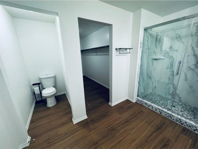 bathroom featuring wood-type flooring, toilet, and walk in shower