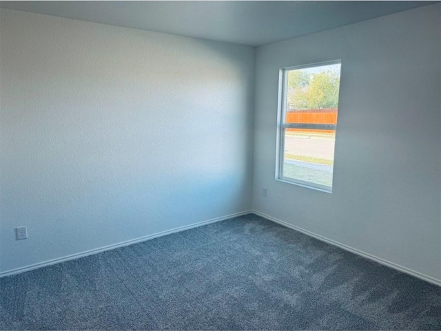 empty room featuring dark colored carpet