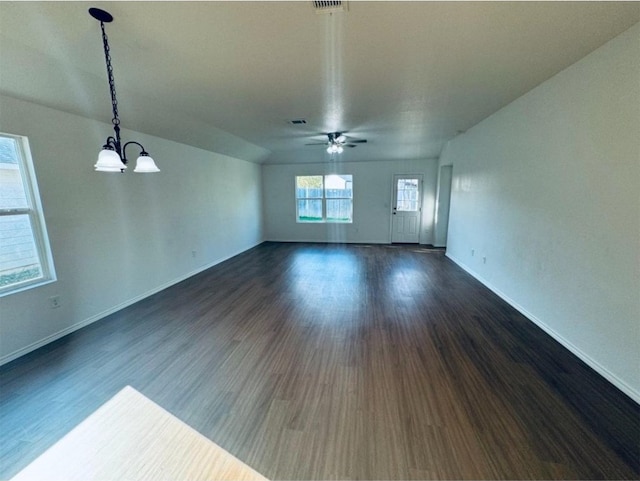 unfurnished living room featuring ceiling fan with notable chandelier and dark hardwood / wood-style flooring