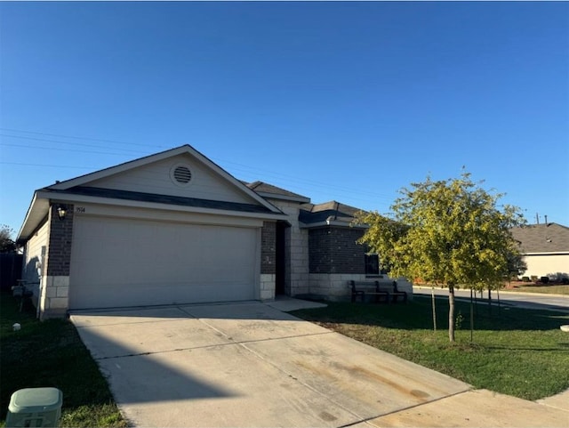 ranch-style home with a garage and a front lawn