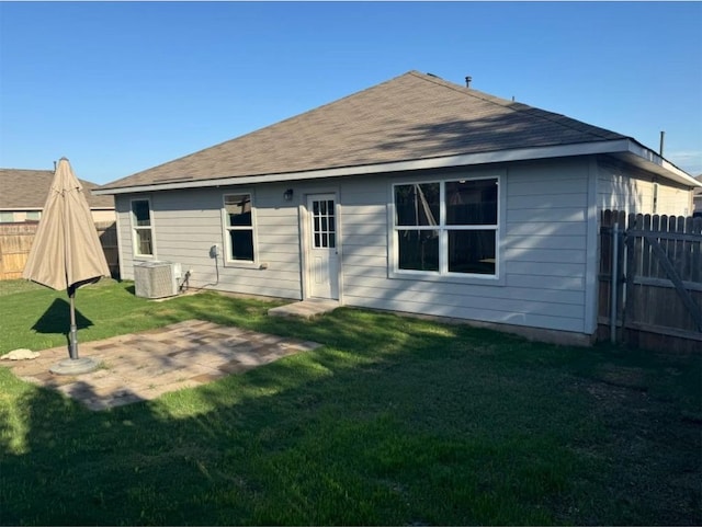 back of property with a lawn and central AC unit