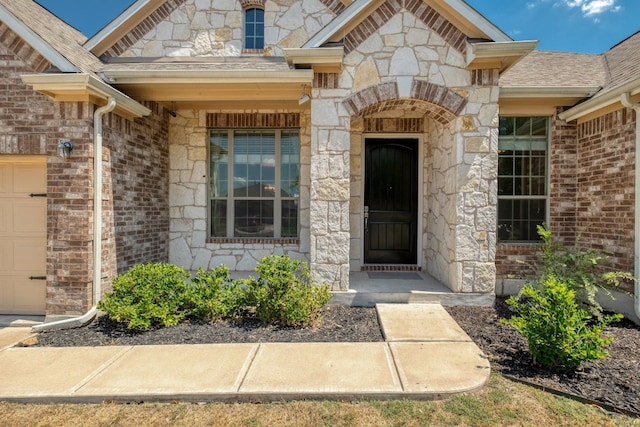 view of exterior entry featuring a garage