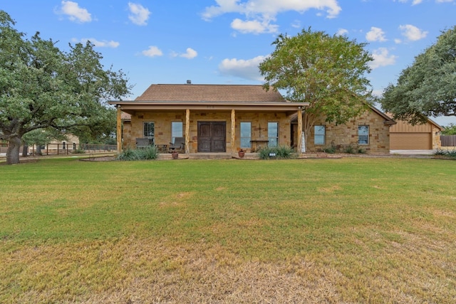 rear view of property with a lawn and a porch