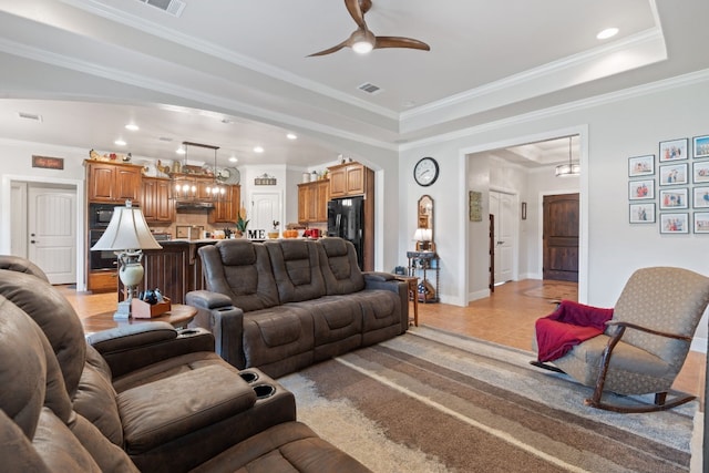 tiled living room with crown molding and ceiling fan