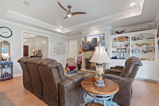 tiled living room with crown molding, a tray ceiling, and ceiling fan