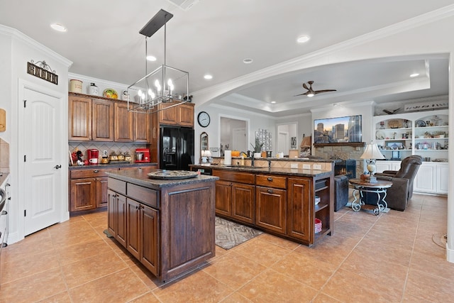 kitchen with a kitchen island, hanging light fixtures, crown molding, light tile patterned flooring, and black fridge with ice dispenser