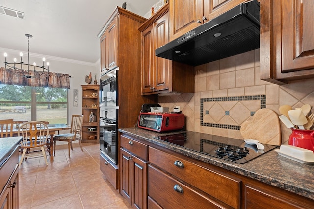 kitchen featuring decorative backsplash, a chandelier, dark stone counters, light tile patterned flooring, and black appliances