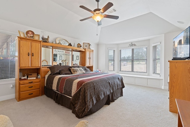 bedroom with light carpet, vaulted ceiling, and ceiling fan