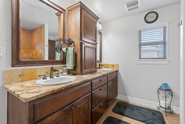 bathroom featuring vanity, tasteful backsplash, and tile patterned flooring