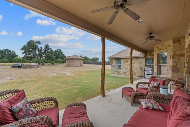 view of patio with a storage shed and ceiling fan