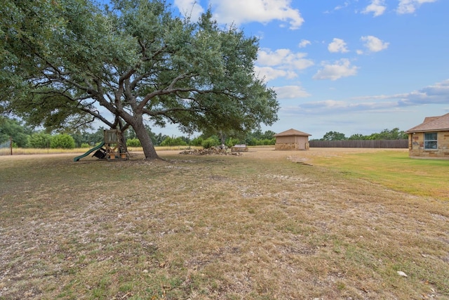 view of yard featuring a shed and a playground