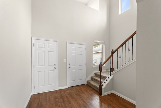 entrance foyer featuring dark wood-type flooring and a high ceiling