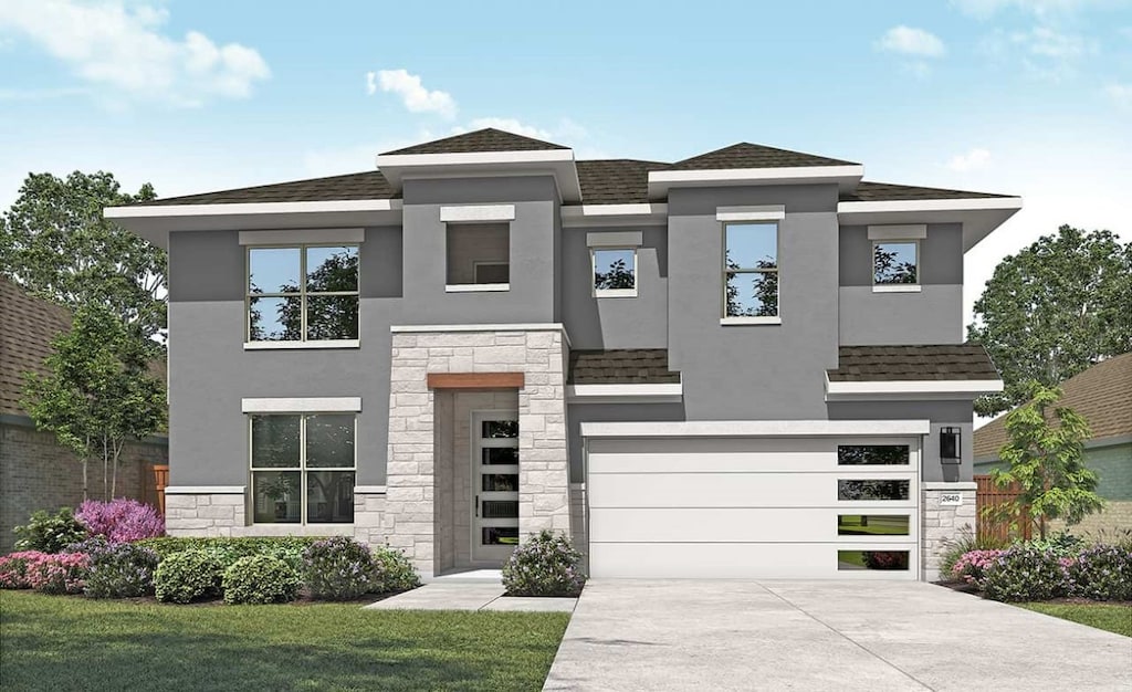 view of front facade with a front yard and a garage