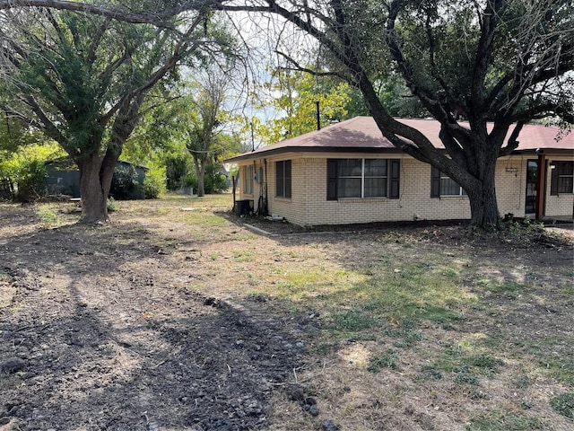 1133 W Bell St, Bartlett, TX 76511 - view of side of home featuring brick siding and cooling unit