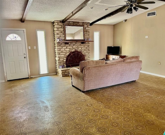 1133 W Bell St, Bartlett, TX 76511 - living room with visible vents, a brick fireplace, beamed ceiling, a textured ceiling, and a ceiling fan