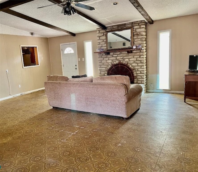 1133 W Bell St, Bartlett, TX 76511 - living area featuring a ceiling fan, a textured ceiling, tile patterned floors, baseboards, and beamed ceiling