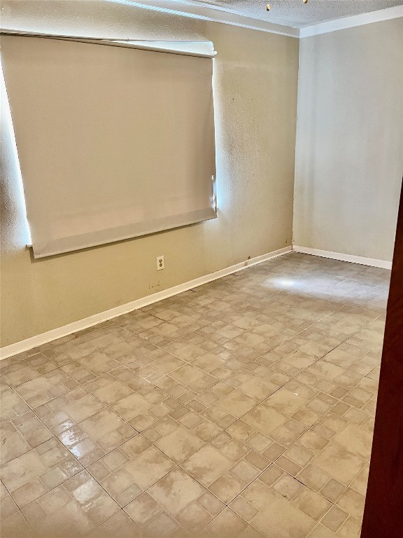 unfurnished room featuring a textured ceiling