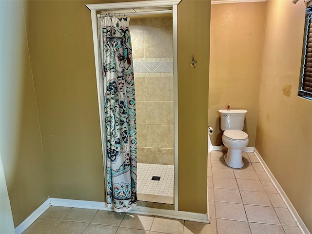 bathroom featuring toilet, tile patterned floors, and a shower with shower curtain