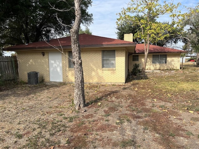 1133 W Bell St, Bartlett, TX 76511 - view of home's exterior with brick siding, cooling unit, a chimney, and fence