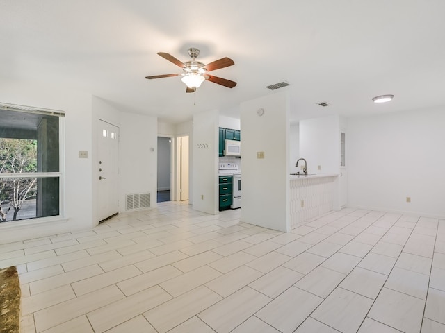 unfurnished living room with ceiling fan