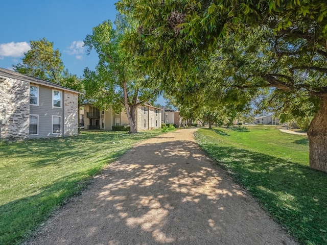 view of property's community with a yard