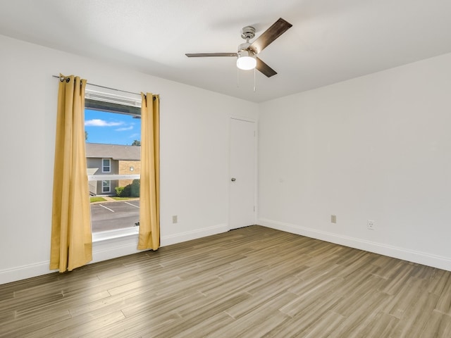 spare room with ceiling fan and light wood-type flooring