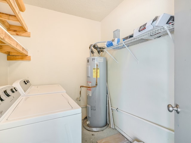 laundry room featuring water heater, a textured ceiling, and separate washer and dryer