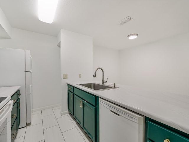 kitchen featuring white appliances, light tile patterned flooring, sink, and green cabinetry