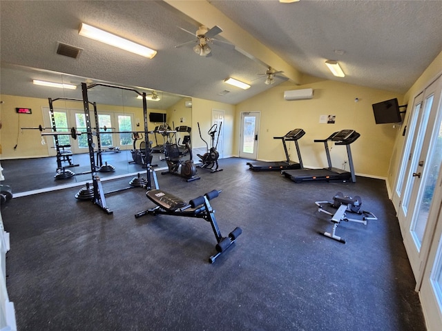 workout area with ceiling fan, a textured ceiling, a wall mounted AC, and lofted ceiling