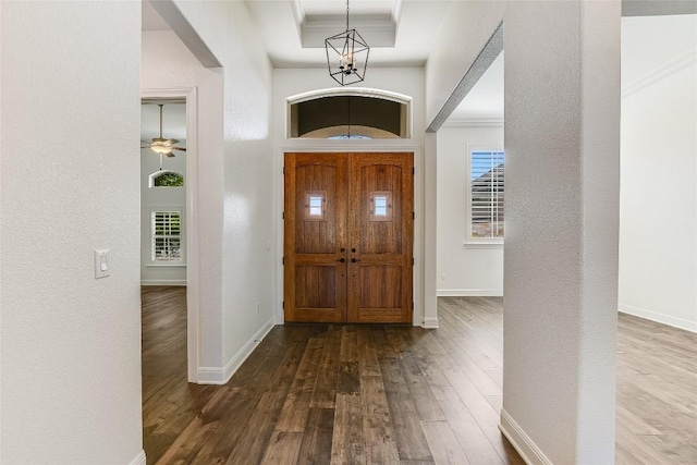 foyer featuring hardwood / wood-style flooring and crown molding