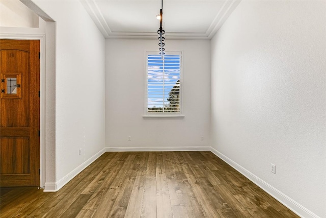 unfurnished dining area featuring hardwood / wood-style flooring and crown molding