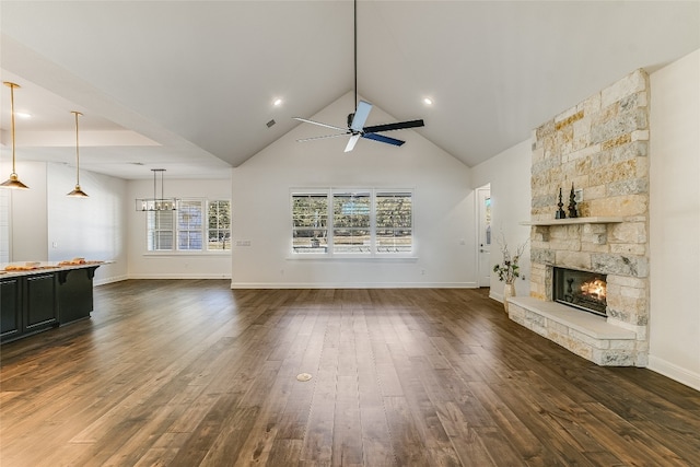 unfurnished living room with dark wood-type flooring, ceiling fan, high vaulted ceiling, and a fireplace