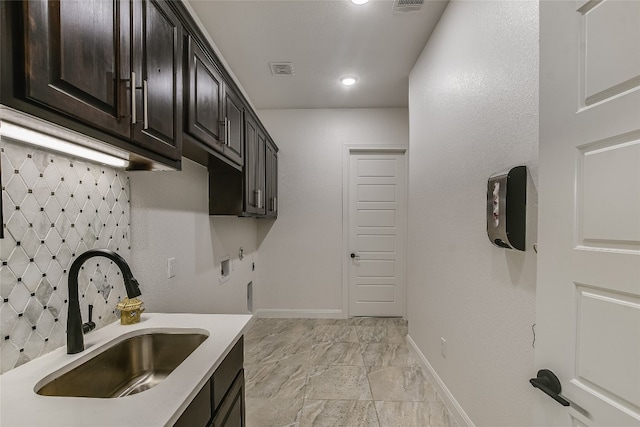 kitchen featuring sink and dark brown cabinetry