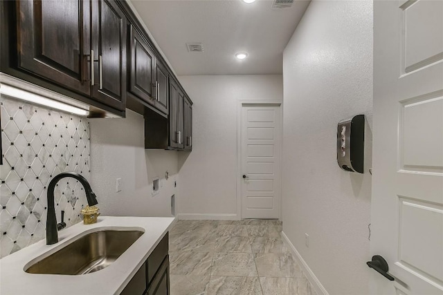 kitchen featuring sink and dark brown cabinets