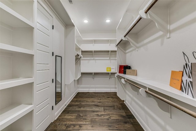 spacious closet with dark hardwood / wood-style floors