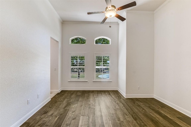 empty room with crown molding, dark wood-type flooring, and ceiling fan