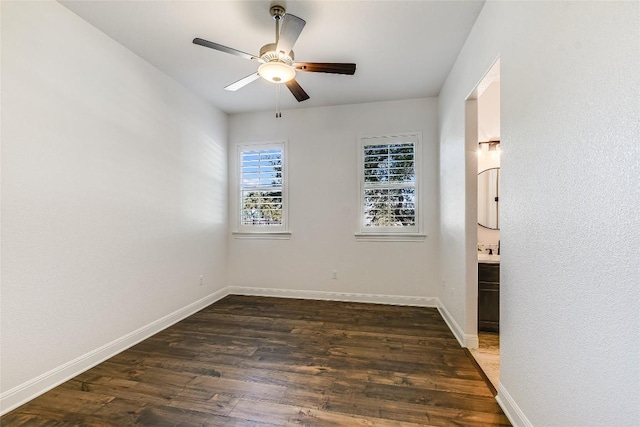 unfurnished room with dark hardwood / wood-style flooring and ceiling fan