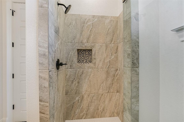 bathroom featuring tiled shower