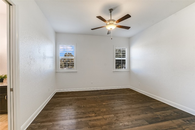 unfurnished room with dark hardwood / wood-style floors and ceiling fan