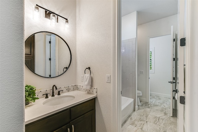 bathroom with toilet, a tub, and vanity