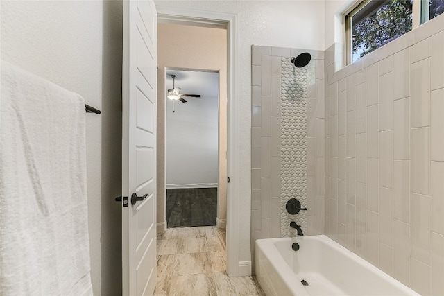 bathroom featuring ceiling fan and tiled shower / bath combo